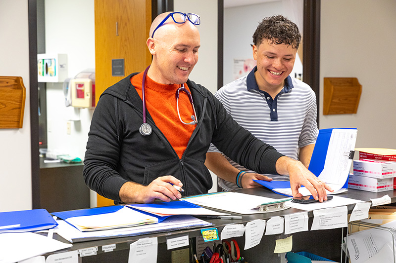Scholar Caleb Flores volunteering at the WelcomeHealth clinic